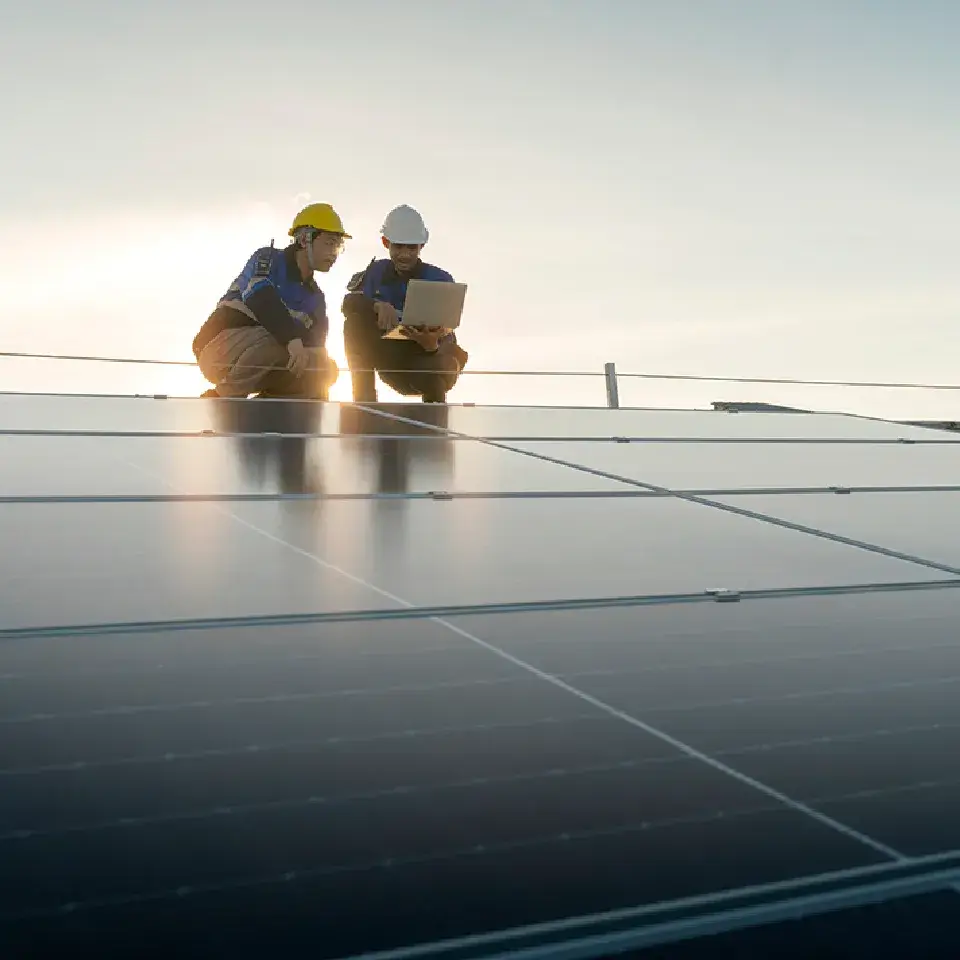 2 men on a solar panel roof
